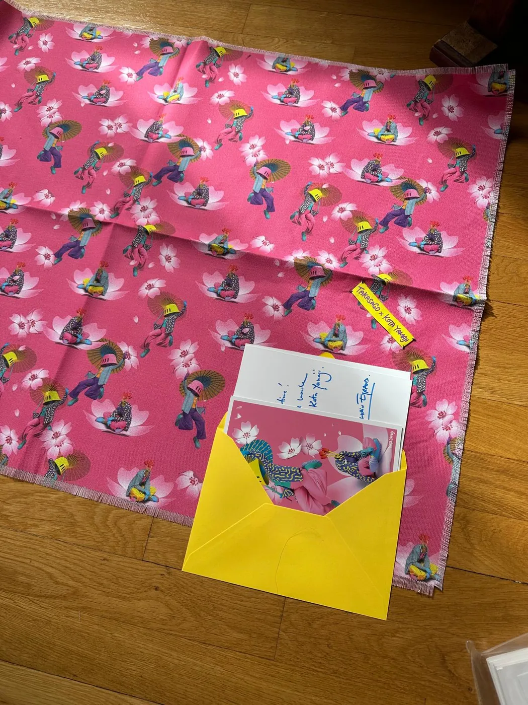 Folded furoshiki with a yellow envelope and note
